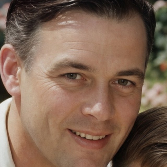Zoomed detail of the father’s face, creased across the cheek after restoration