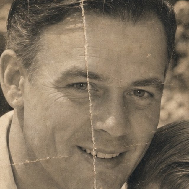 Zoomed detail of the father’s face, creased across the cheek before restoration