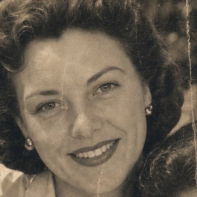 Zoomed detail of the mother’s eyes and smile before restoration